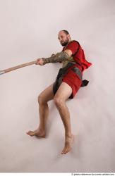 Man Adult Average White Fighting with spear Laying poses Casual